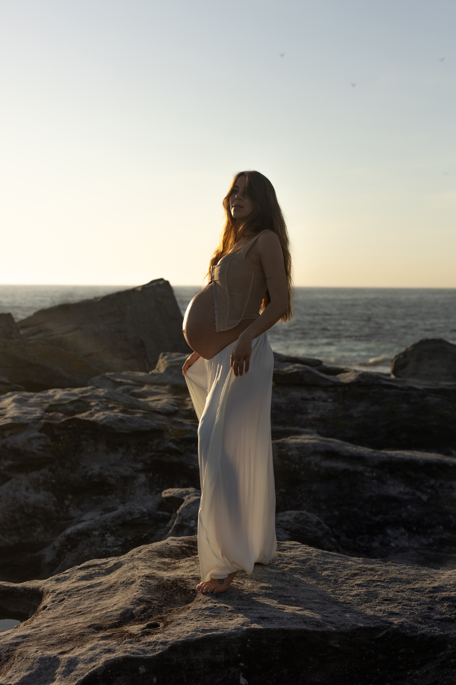 Sculptural coastal maternity portrait