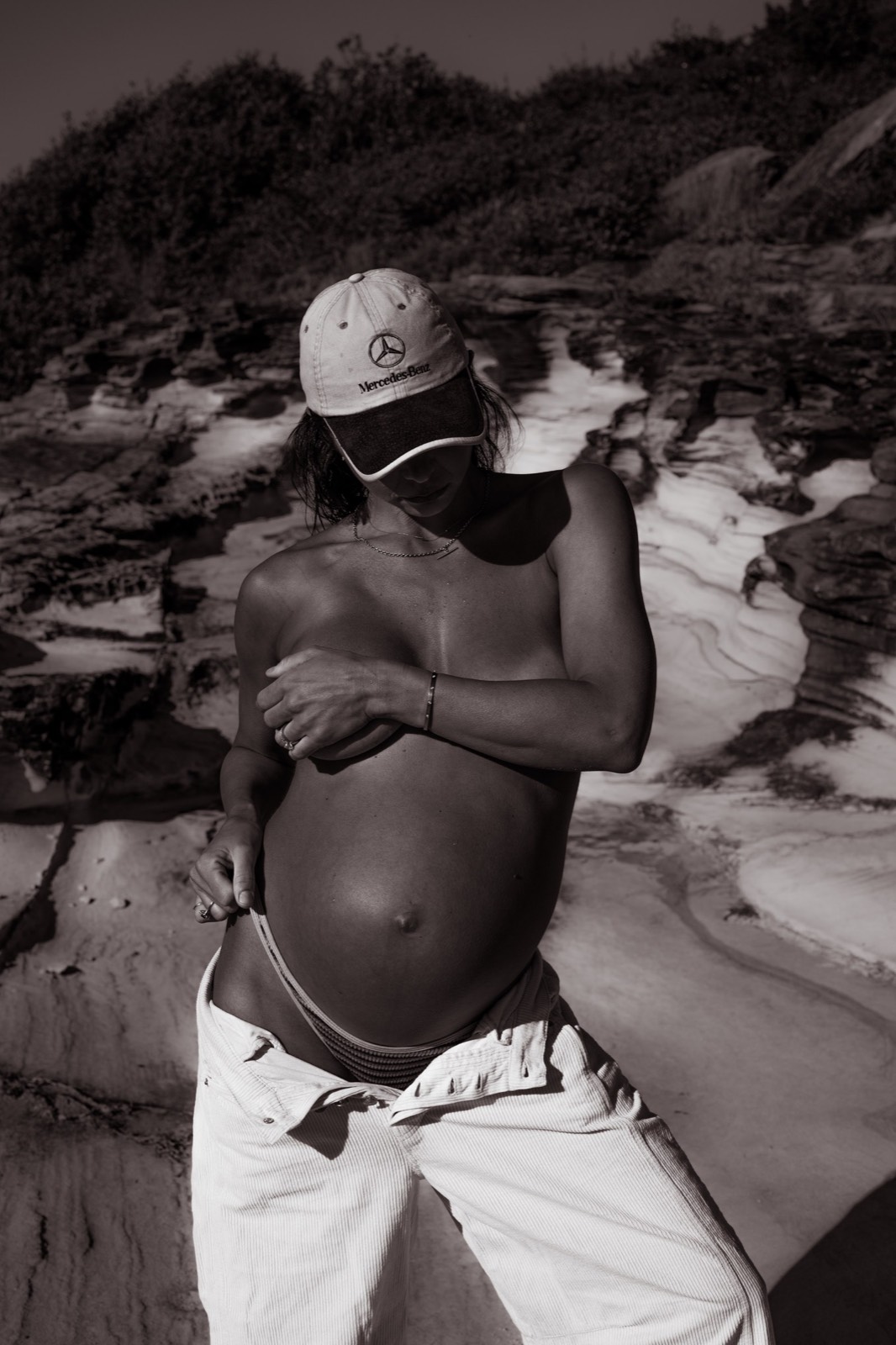 Fashion-led black and white maternity portrait in a vintage cap