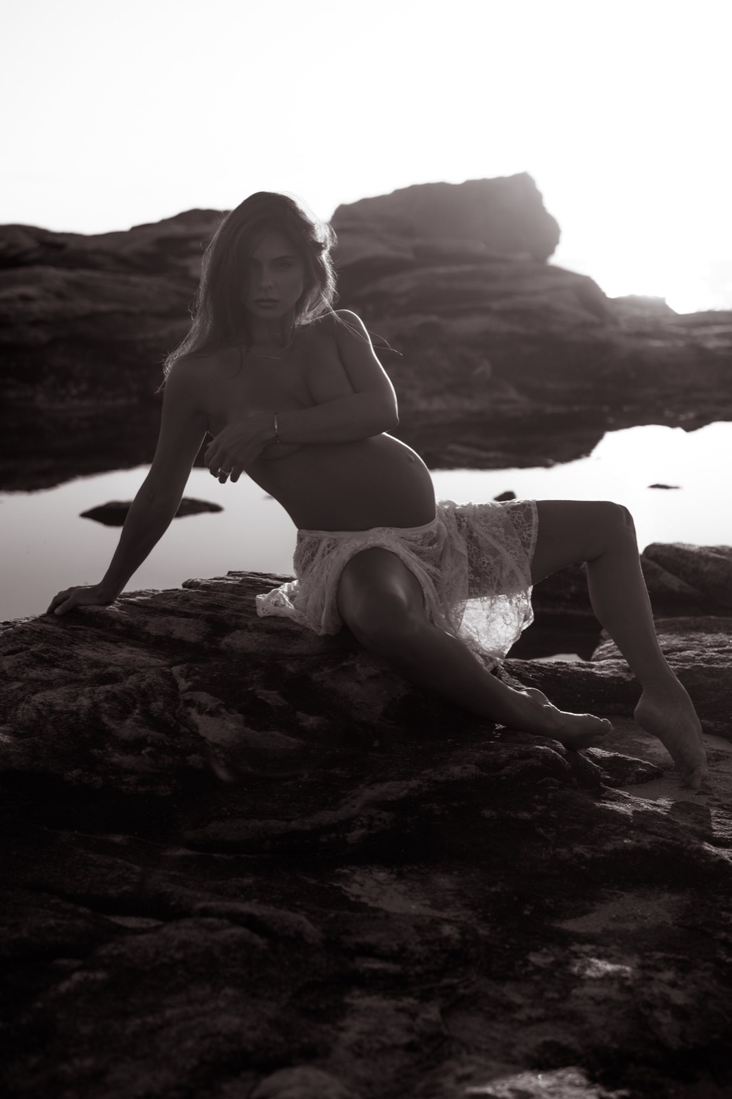Seated black and white maternity portrait in lace