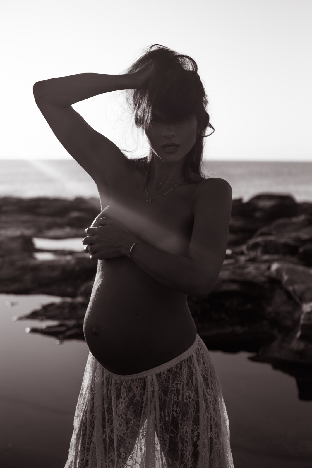 Shadowed black and white maternity portrait in lace